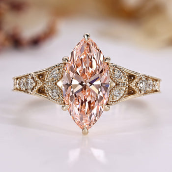 Art Deco diamond ring with marquise and pink details.
