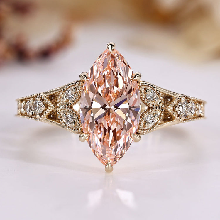 Art Deco diamond ring with marquise and pink details.