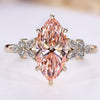 Marquise engagement ring with pink center diamond.