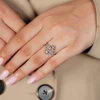Pink marquise diamond ring with four claw prong setting.