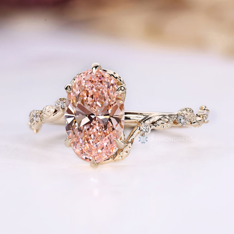 Pink center lab grown diamond ring with bypass setting.
