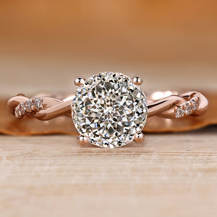 Portuguese diamond ring with hidden halo and round diamond.