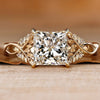 Princess cut diamond ring with round side stones.