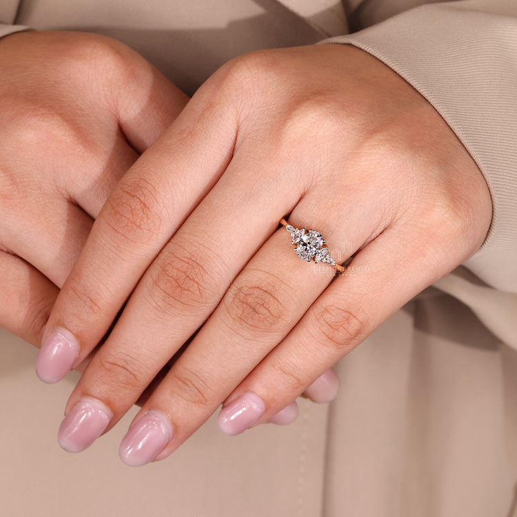 Muse setting oval ring with marquise and round diamonds.