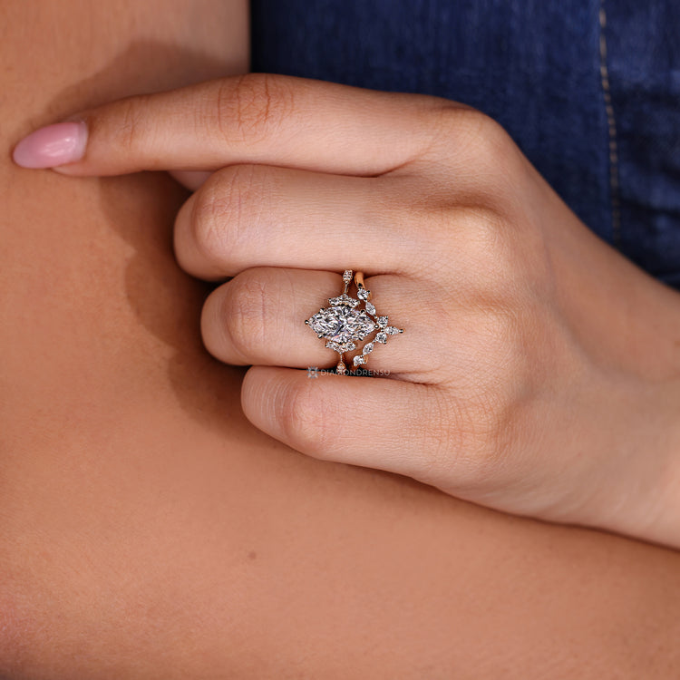 Round side stones complement this marquise wedding ring.