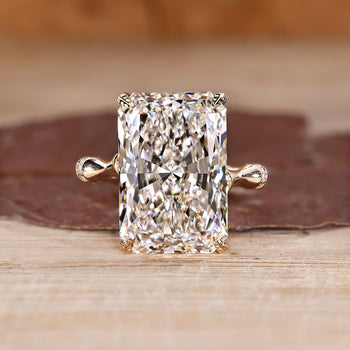Radiant cut diamond ring with round diamond distance pave band.
