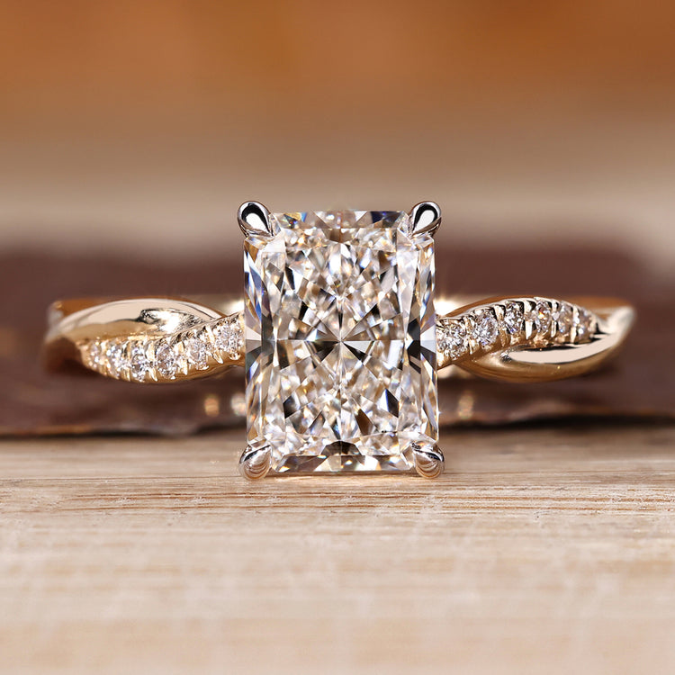 Radiant cut diamond ring with twisted shank and twisted pave band design.
