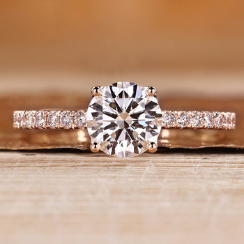 Round cut diamond ring with tulip setting and pave style with round accents.