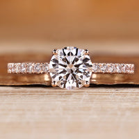 Round cut diamond ring with tulip setting and pave style with round accents.