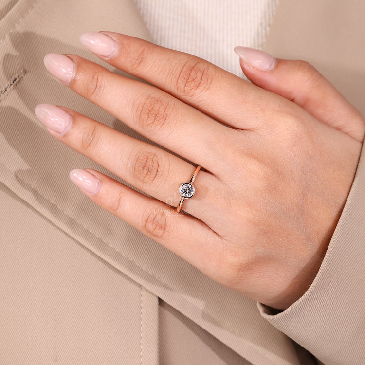 Handmade round diamond ring with smooth bezel setting.