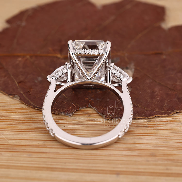 10 carat emerald cut diamond ring with round cut pave band.
