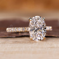Handmade oval cut diamond ring with round cut hidden halo design.