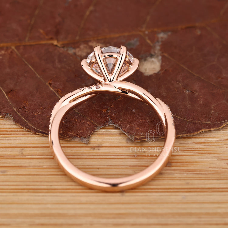 IGI certified round diamond ring with twisted shank and pave accents.