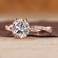 Round diamond ring with twisted shank and lab grown diamond.