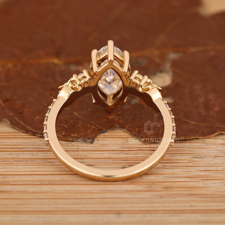 Marquise cut diamond ring with flower design and pave band.