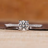 Round diamond ring with round cut pave setting and tapered shank.