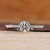 Round diamond ring with round cut pave setting and tapered shank.