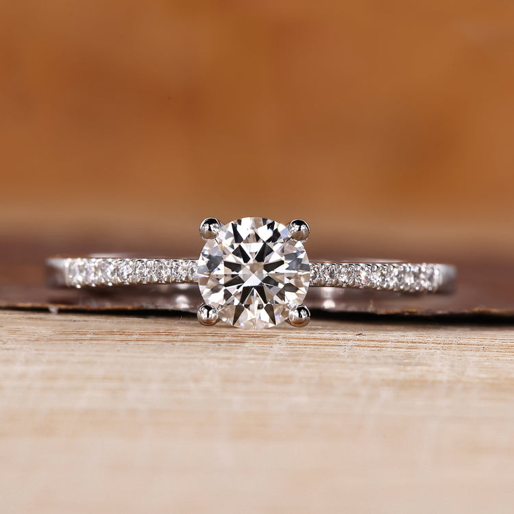 Round diamond ring with round cut pave setting and tapered shank.