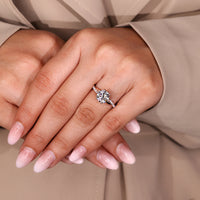 Six claw prong round diamond engagement ring with pave band.