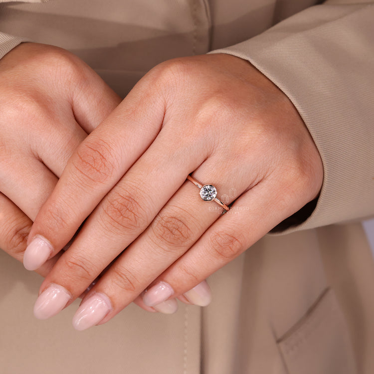 Round lab diamond ring with clean bezel set design.