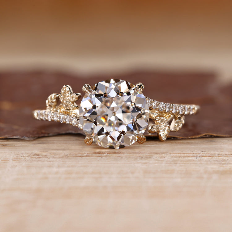 Nature inspired ring with round old european cut diamond leaf design.
