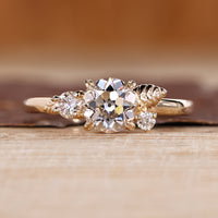 Nature inspired engagement ring with round old European cut diamond.
