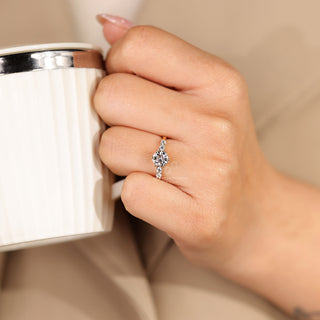 Five stone ring with round cut side diamonds and tapered shank.