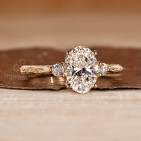 Handmade oval diamond ring with round side stones and filigree.