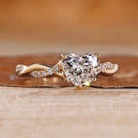 Four prong setting with twisted shank with round accents.