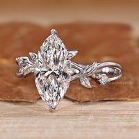 Marquise diamond ring with twisted shank and hidden halo design.