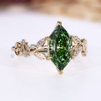 Green Dutch marquise engagement ring with round and marquise side stones.