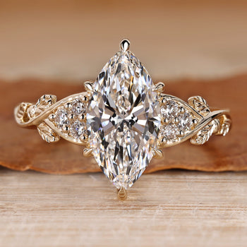 Marquise diamond ring with nature inspired style and round side stones.