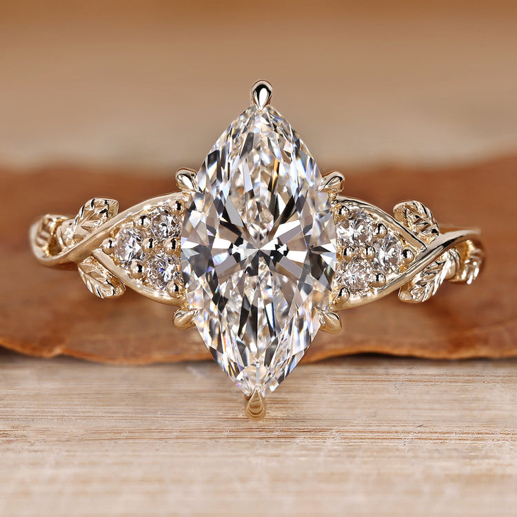 Marquise diamond ring with nature inspired style and round side stones.