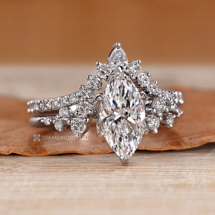 Marquise ring with pear and round diamond side stones.