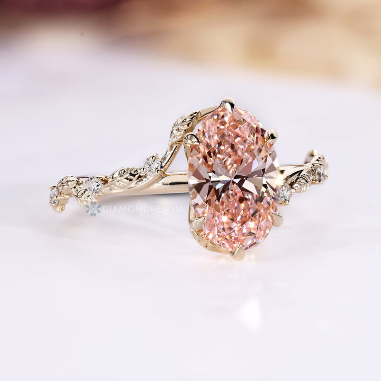 Oval engagement ring with round side stones and tulip setting.