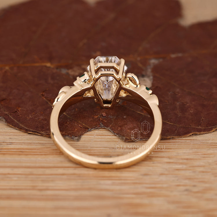 Handmade coffin ring with round side stones and prong setting.