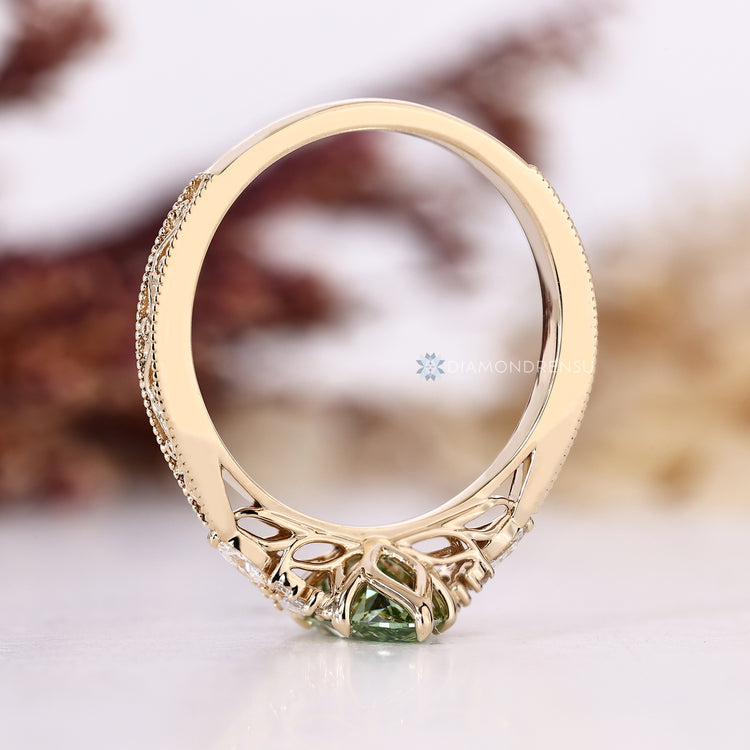 Art Deco diamond ring with a green marquise center and tapered shank.