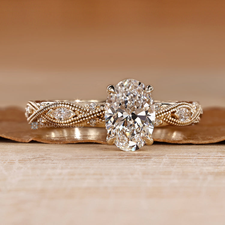 Vintage oval diamond ring with milgrain details.