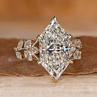 Dutch marquise engagement ring with round stones in a hidden halo.