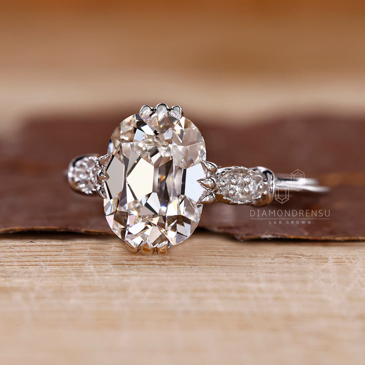 Vintage style diamond ring with fishtails prong and milgrain accents.

