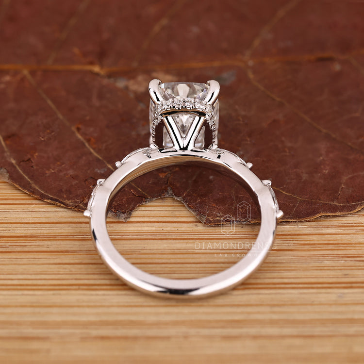 IGI certified elongated cushion cut ring with four tab prong and pave setting.