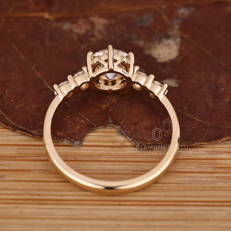 Five stone diamond ring with round side stones and clean setting.