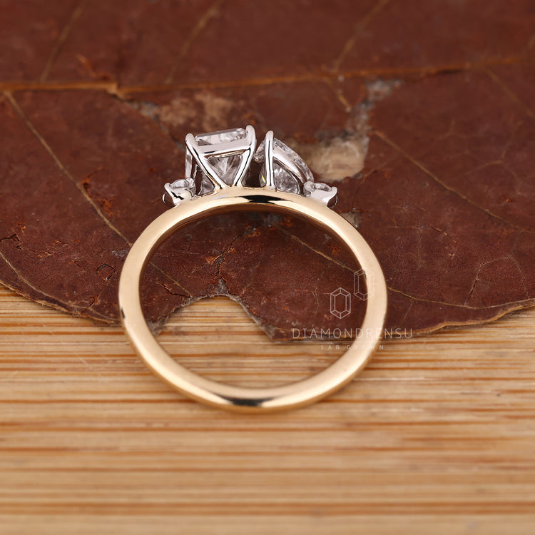 IGI certified two stone ring with radiant cut diamond and pear accent.