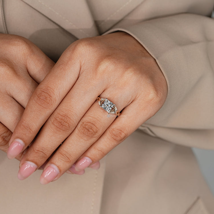 Princess cut diamond ring with round side stones and a tulip setting.