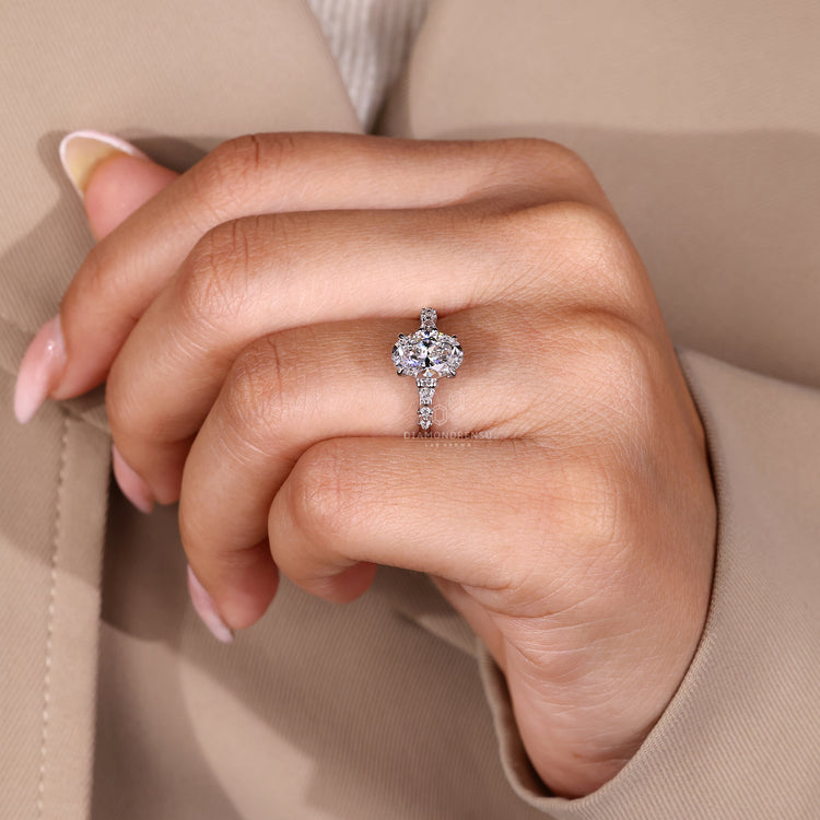 Oval cut engagement ring with pear and round side stones and seven stones design.
