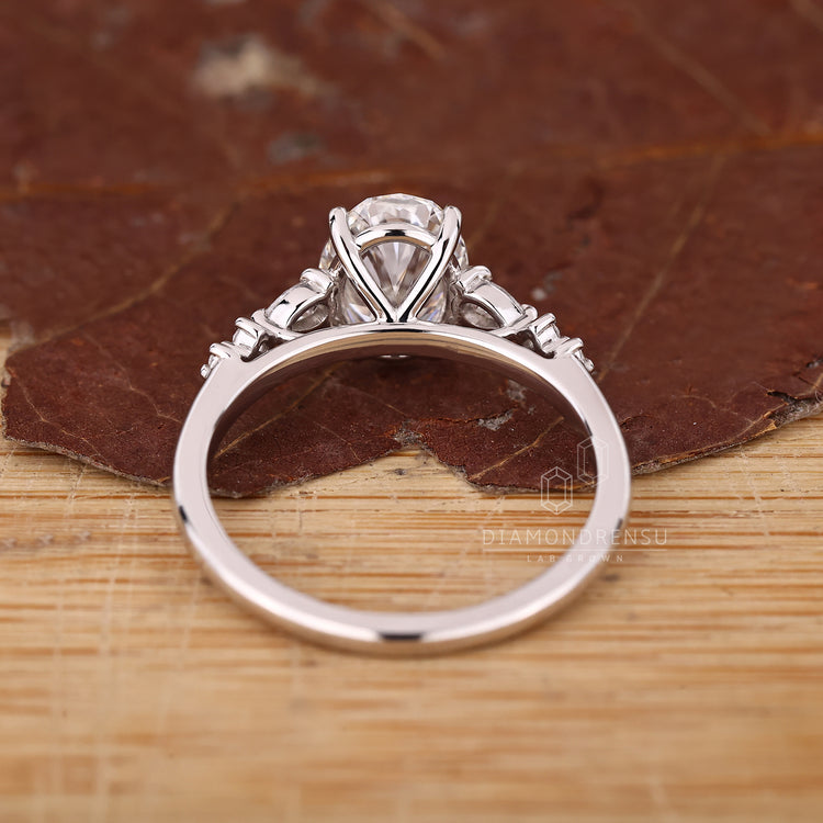 Oval cut diamond engagement ring with IGI certification and pear side stones.