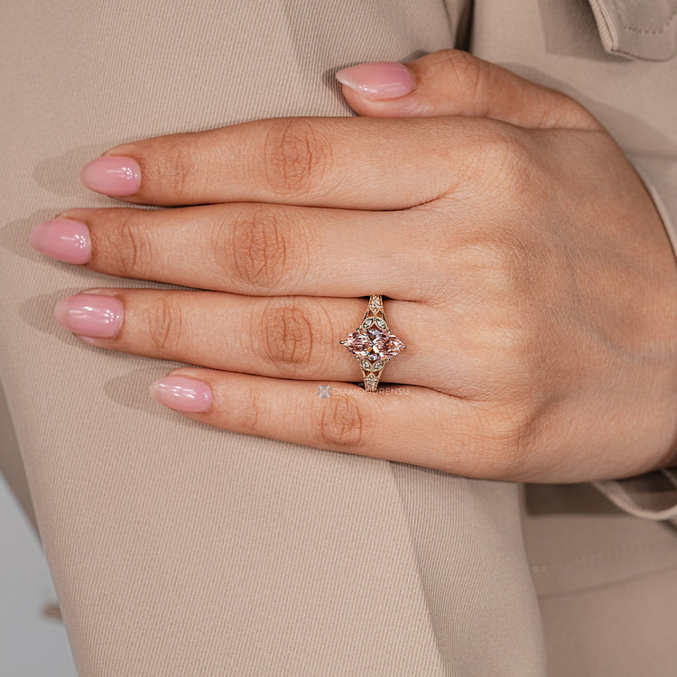 Lab grown diamond with round side stones and marquise shape outline.