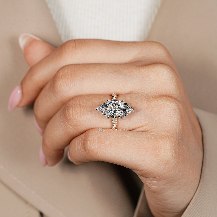 Six claw prong setting secures the center stone.