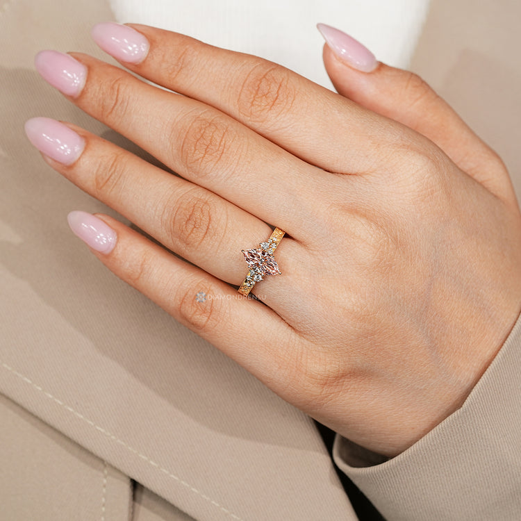 Tulip setting supports the pink center stone.