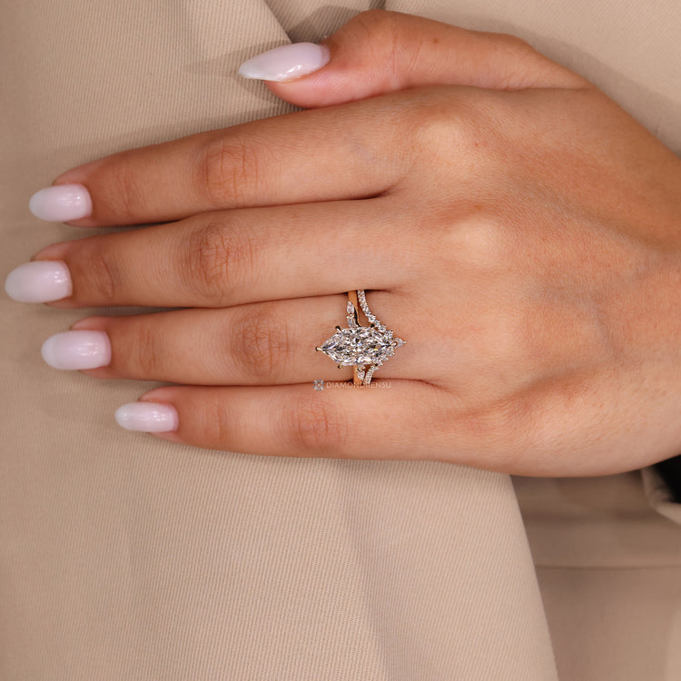 Diamondrensu presents a Dutch marquise wedding ring with bridge accent.